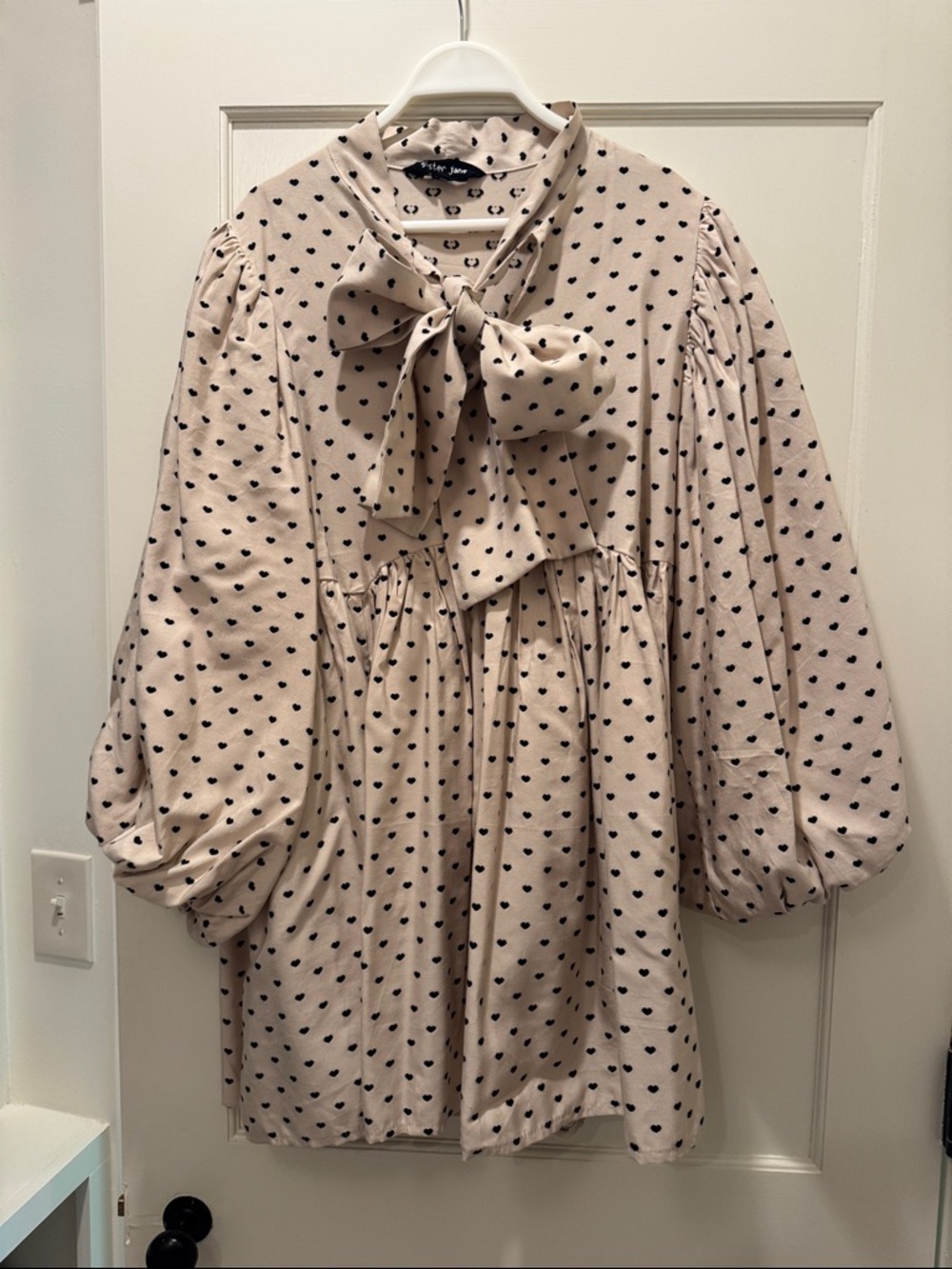 Sister Jane Cream Mini Dress with Black Heart Print and Bow Neck